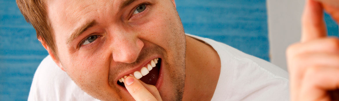 Почему шатаются зубы у взрослых